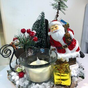 Handmade holiday candle holder features Santa Claus.